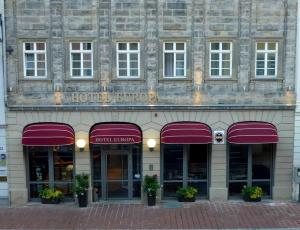 a building with purple awnings on the front of it at Hotel Europa in Bamberg