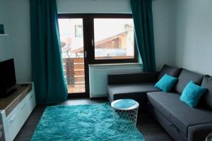 a living room with a couch and a large window at FeWo Topas Balingen in Balingen