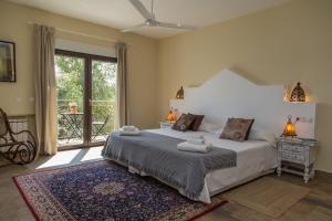 a bedroom with a bed and a large window at La Casona del Torcon in Navahermosa