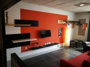 a living room with a red wall at 1V - LUXURY APARTMENT NEAR BEACH in Puerto del Rosario