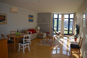 a living room with a couch and a table at Marina de Albufeira Orada Resort - 2-bed apartment with huge pool in Albufeira