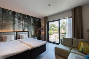 Postel nebo postele na pokoji v ubytování Fletcher Hotel-Restaurant Jagershorst-Eindhoven