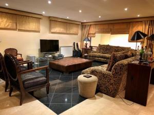 a living room with a couch and a tv at Charming House Portas da Maia in Maia