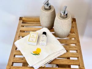 a table with a towel and two vases at Lemon Tree Retreat at El Amparo in Alhama de Granada