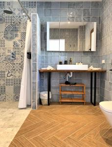 a bathroom with a sink and a shower and a toilet at El Amparo in Alhama de Granada