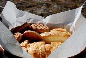 a basket of bread and cookies in a basket at Agriturismo Su Tiresi in Cala Gonone