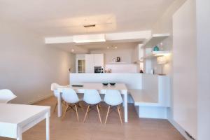 a kitchen and dining room with a table and chairs at Sea View in Ostend