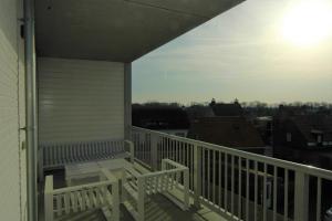 a balcony with a view of a city at La Promenade Le Normandy 54-201 in Cadzand