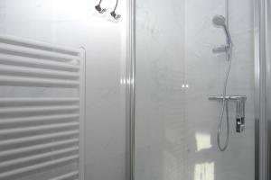 a bathroom with a shower with a glass door at La Promenade Le Normandy 54-201 in Cadzand +9 photos