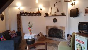 a living room with a couch and a fireplace at Michalis Anoyia Traditional Stonehouse in Kathikas