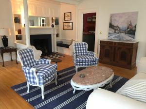 a living room with three chairs and a coffee table at The Belmont Inn in Camden