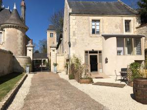 an old stone house with a driveway in front of it at Domaine Plessis Gallu - vacation cottage rental in Azay-le-Rideau