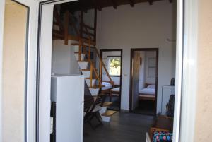 a room with a staircase and a living room with a refrigerator at Beaufort apartment in Stoupa