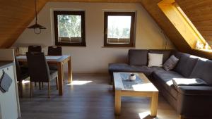 a living room with a couch and a table at Ferienwohnung Dresden Nickern in Dresden +9 photos