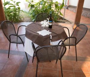 a table with chairs and a bottle of wine on it at Baia di Zambrone in Zambrone +36 photos
