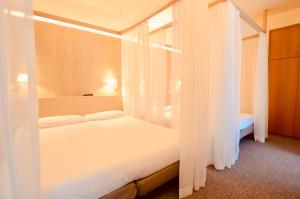 Letto o letti in una camera di Albergo Sorriso
