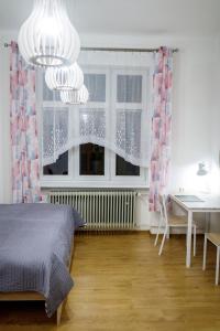 Schlafzimmer mit einem Bett, einem Tisch und einem Fenster in der Unterkunft Útulný druhý domov v srdci Žiliny in Žilina