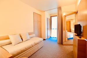 Letto o letti in una camera di Albergo Sorriso