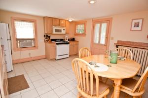 a kitchen with a wooden table and a table and chairs at Thomas Webster House in Cape May