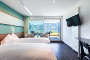 Postel nebo postele na pokoji v ubytování Superior Hotel Nidwaldnerhof