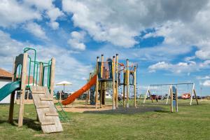 an empty playground with a slide and a slideintend at Camping Pods, Seaview Holiday Park in Whitstable