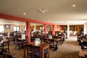 a restaurant with tables and chairs in a room at Camping Pods, Seaview Holiday Park in Whitstable