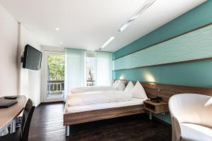 Ein Bett oder Betten in einem Zimmer der Unterkunft Superior Hotel Nidwaldnerhof