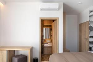 a bedroom with white walls and a bed and a mirror at 4 SMART HOTEL in Olomouc