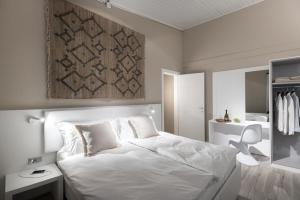 una camera da letto con un grande letto bianco e uno specchio di CP Resort a Taverne