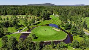 an overhead view of a golf course with a lake at Auberge les Etchemins in Sainte-Germaine-du-Lac-Etchemin