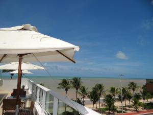 a view of the beach from the balcony of a resort at FLAT A BEIRA MAR DE JOÃO PESSOA com AR in João Pessoa