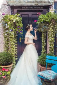 a woman in a wedding dress drinking from a bottle at Bath Place Hotel in Oxford