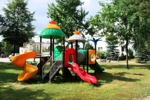 a group of playground equipment in a park at Hotel Książę Poniatowski in Lesznowola