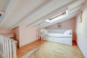 a bedroom with a white bed in a attic at ID 216 Cosy Duplex Tour Eiffel area in Paris