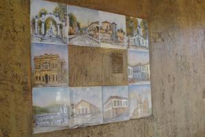 a collage of pictures of buildings on a wall at POUSADA CASARÃO NORONHA KAUAGE in Cristina