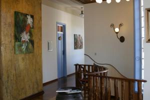 a room with a staircase and a painting on the wall at POUSADA CASARÃO NORONHA KAUAGE in Cristina