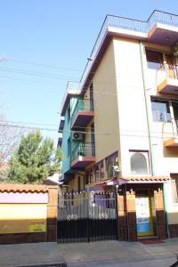 a building with a fence in front of it at Hotel Color in Asenovgrad