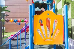 a playground with a slide in front of a building at Accra Fine Suites - The Pearl In City in Accra