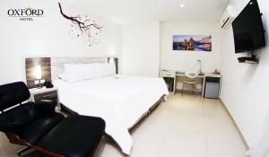 Postel nebo postele na pokoji v ubytování Hotel Oxford Barranquilla