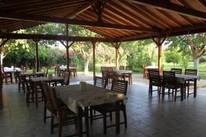 an outdoor dining area with tables and chairs at Ozge Bungalow Hotel in Cıralı