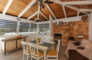 a living room with a table and a fireplace at Secluded Seaside Holiday Home in Milna