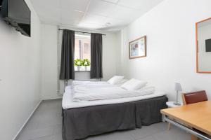 Voodi või voodid majutusasutuse Kalmar Hotell toas