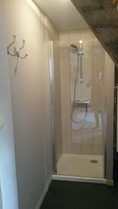 a bathroom with a shower with a glass door at Laclos des champs in Vadencourt