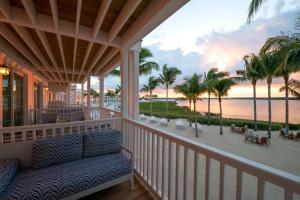 a porch with a couch and a view of the beach at Isla Bella Beach Resort & Spa - Florida Keys in Marathon