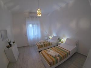 Posteľ alebo postele v izbe v ubytovaní Oudeis Holidays Apartments Tropea