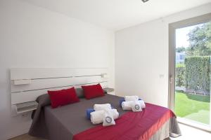 a bedroom with a large bed with towels on it at Villa Salines House in Alcudia