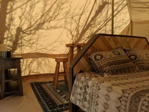 a bedroom with a bed in a tent at FunStays Glamping Setup Tent in RV Park #6 OK-T6 in Moab