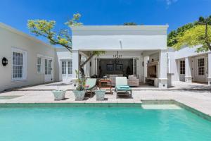 a swimming pool in front of a house at Dalton House in Cape Town