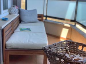 a couch and a bench on a balcony at Charming Beach Holiday Apartment in Lozenets +9 photos