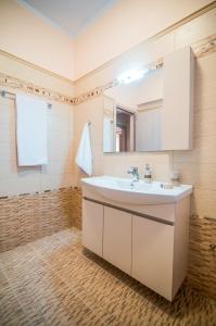 a bathroom with a sink and a mirror at Xristiana's House by CorfuEscapes in Kastanéa +33 photos